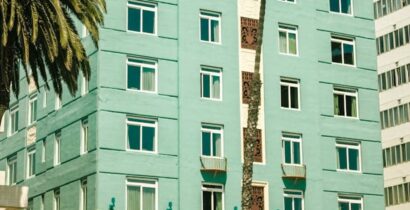 Charming view of The Georgian Hotel, a notable Santa Monica landmark with palm trees.