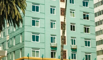 Charming view of The Georgian Hotel, a notable Santa Monica landmark with palm trees.