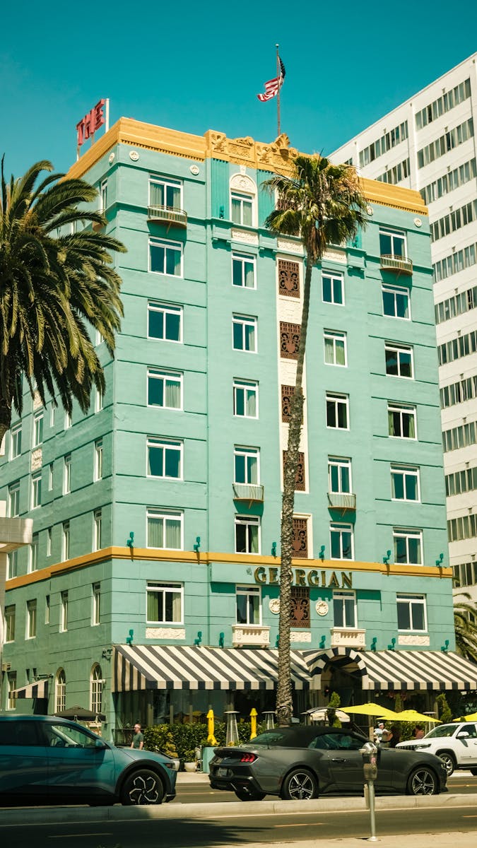 Charming view of The Georgian Hotel, a notable Santa Monica landmark with palm trees.