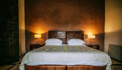 Inviting bedroom setting with plush bedding and ambient lighting for a relaxing atmosphere.